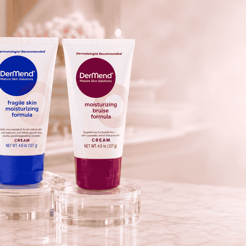 Two tubes of Dermend skincare product on a blurred background