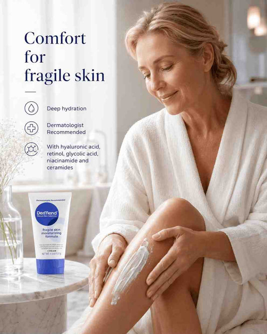 Woman applying moisturizer to her leg with a bottle of Dermender product on a marble surface.