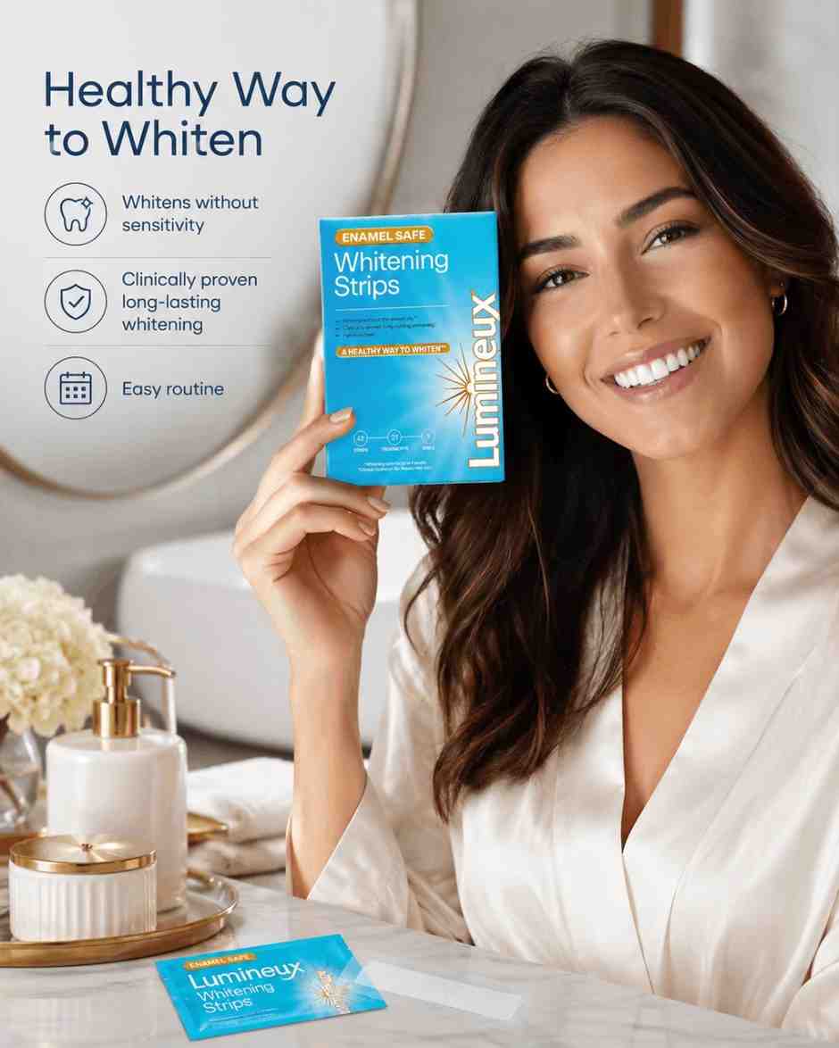 Woman holding Lumineux Whitening Strips packaging in a bathroom setting