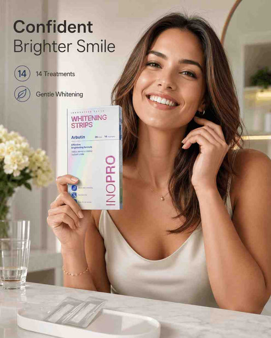 Woman holding INOPRO whitening strips with a bright smile in a bathroom setting