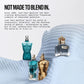 Three Jean Paul Gaultier perfume bottles displayed on a draped light blue fabric surface with promotional text on a white background. The bottles include a teal ribbed bottle, a translucent blue bottle with a gold atomizer, and a metallic gold ribbed bottle with a gold crown cap.