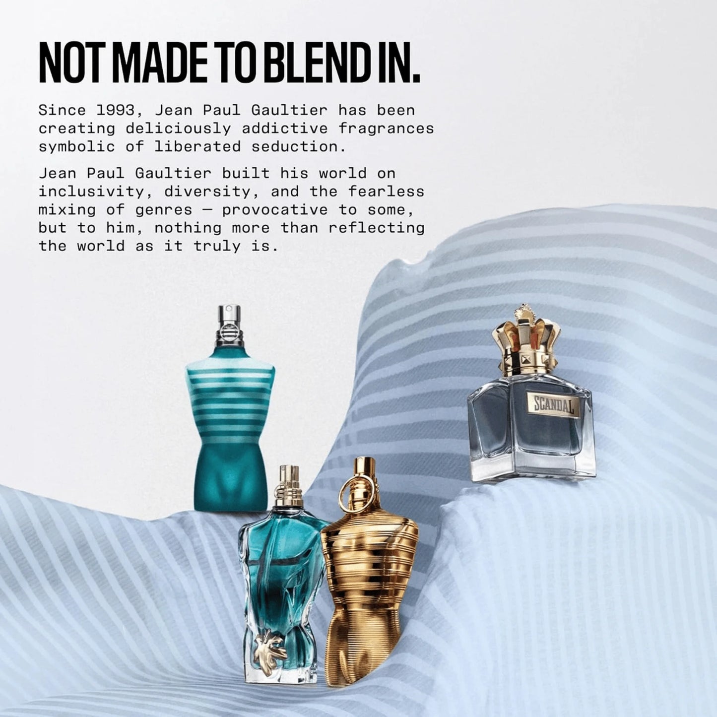 Three Jean Paul Gaultier perfume bottles displayed on a draped light blue fabric surface with promotional text on a white background. The bottles include a teal ribbed bottle, a translucent blue bottle with a gold atomizer, and a metallic gold ribbed bottle with a gold crown cap.