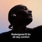 Person wearing wireless earbuds with text 'Redesigned fit for all-day comfort' on a gradient background