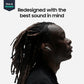 A side-profile portrait of a person with long dark dreadlocks wearing a small white in-ear earbud. Large text at the top reads 'Redesigned with the best sound in mind,' and a small 'New & Notable' badge appears in the upper left on a light gray background.