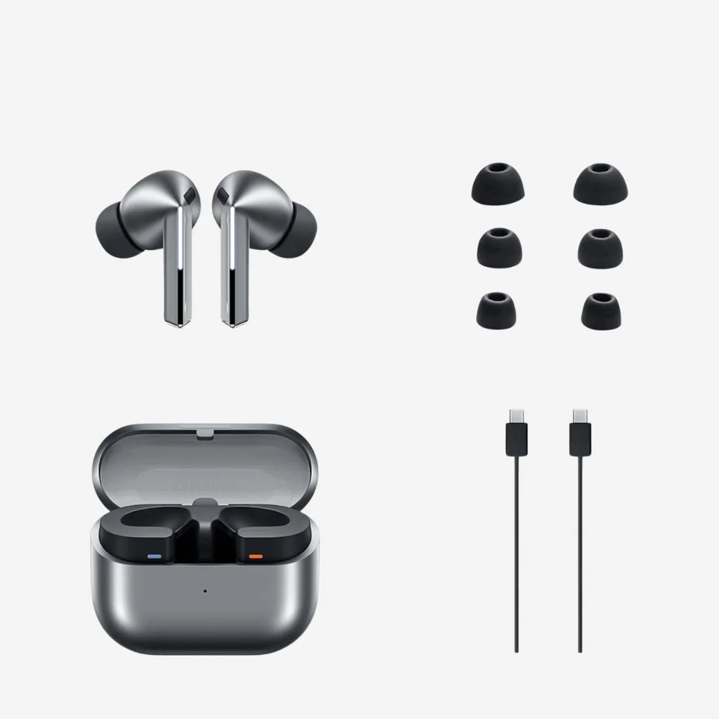 True wireless earbuds in metallic gray shown with an open charging case, six black ear tips, and two charging cables on a light gray background.