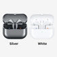 Two pairs of wireless earbuds in open charging cases shown side by side on a light gray background, labeled Silver and White. The left case is metallic silver with black earbud interiors and small blue and orange indicator lights; the right case is white with matching earbuds and lights.