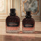 Two Valentino perfume bottles with textured rose-gold and clear glass bodies, black caps, and black labels with gold lettering, displayed on a marble surface with a classical interior background.