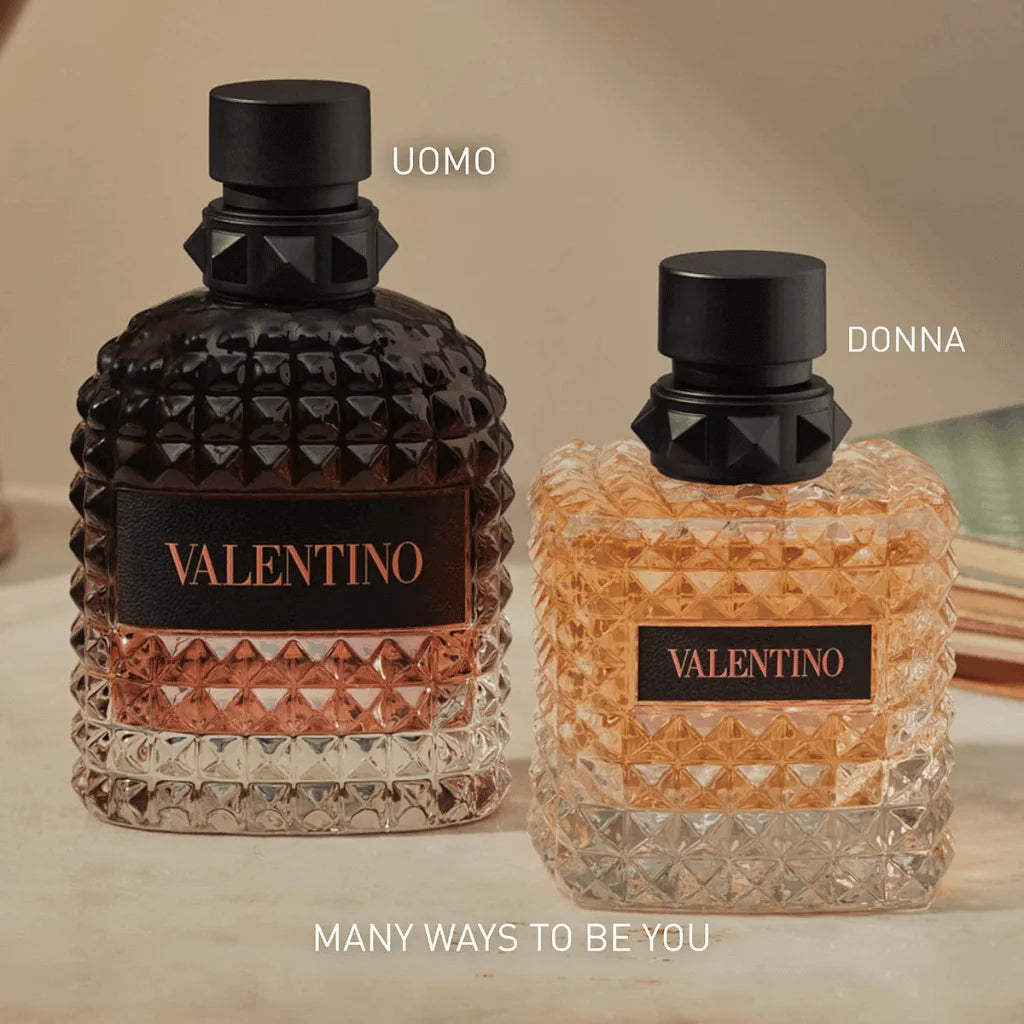 Two textured glass perfume bottles with black caps on a beige surface. The left bottle is dark brown with rose-gold-toned lower glass and a black label reading VALENTINO.