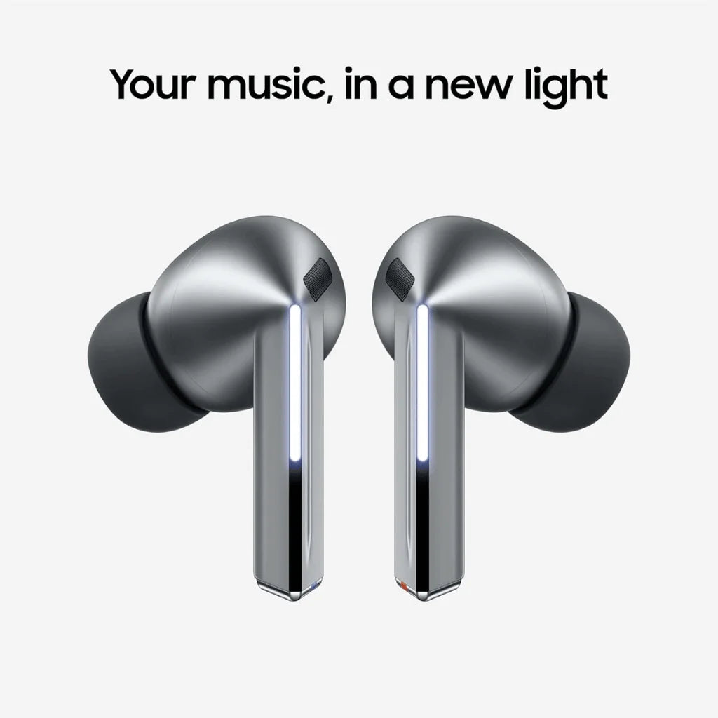 A pair of metallic silver wireless earbuds with black silicone tips, shown against a light gray background with the text 'Your music, in a new light' above them.